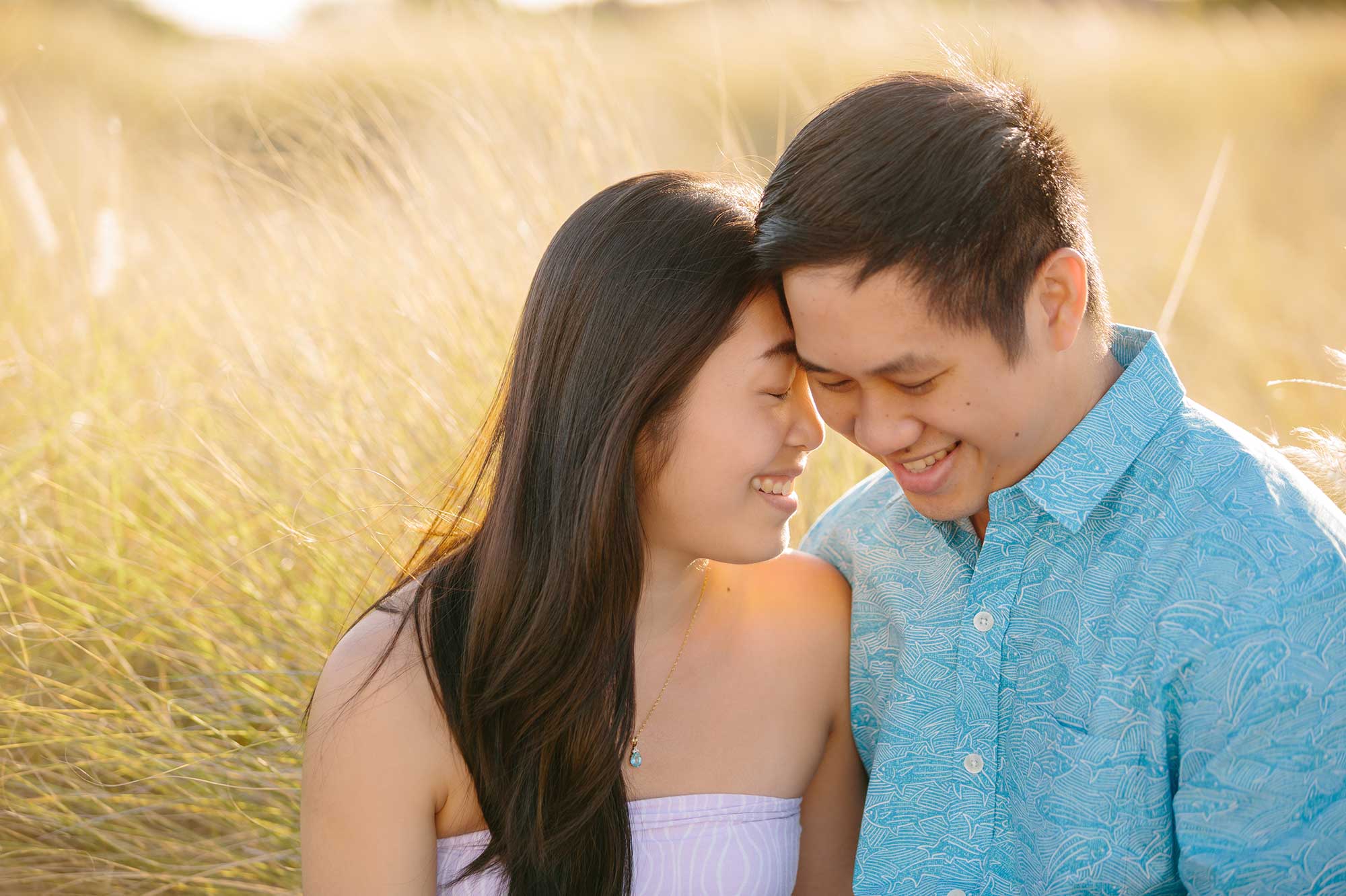 image of couple cuddling in the grass