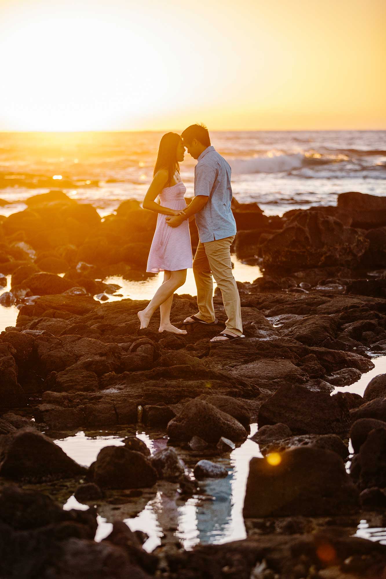image of couple standing on lava rocks