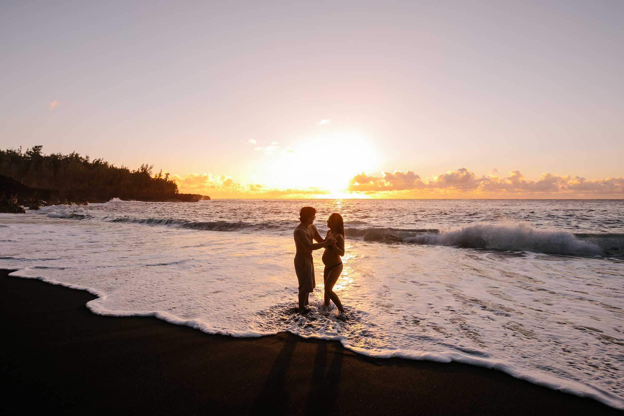 image of couple on the beach at sunset