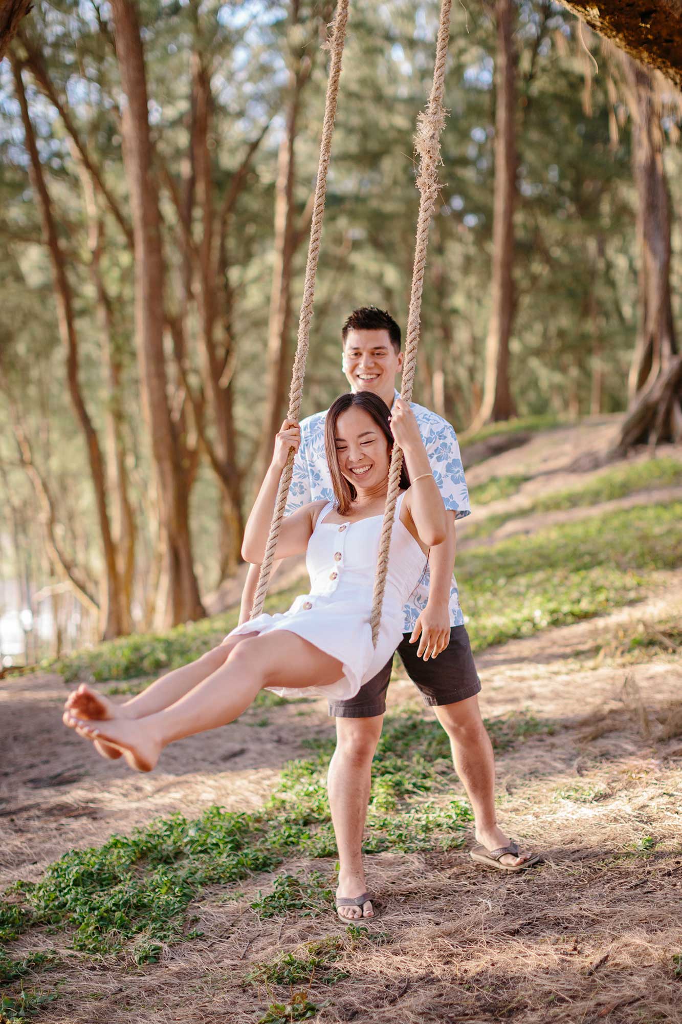 image of man pushing his girlfriend on a swing