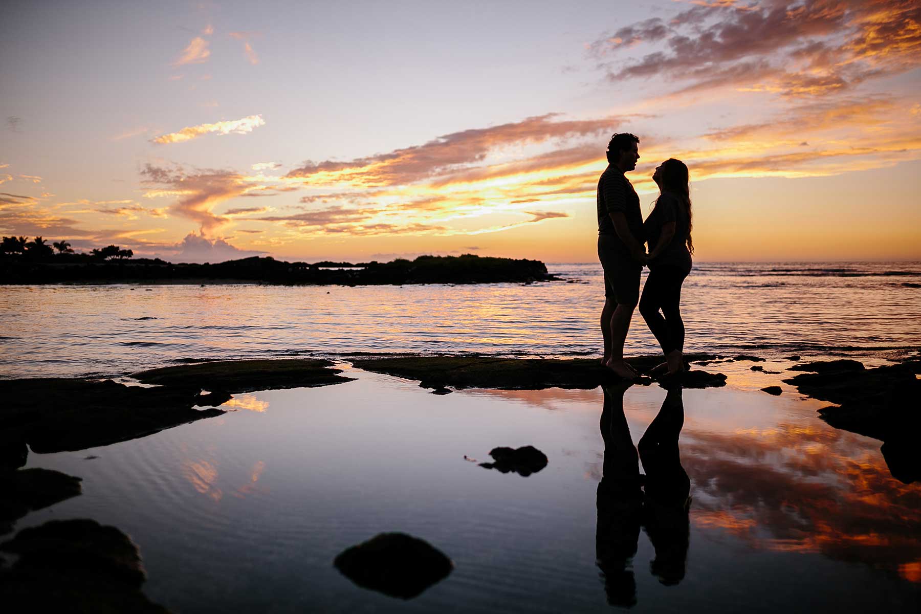 image of couple standing near a tidepool