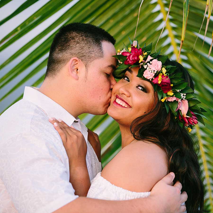 image of man kissing his girlfriend on the cheek