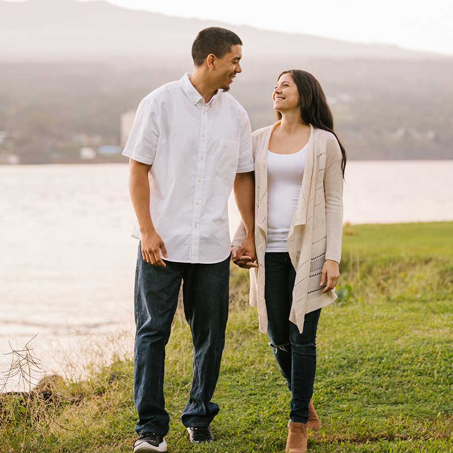 image of couple walking together near the water.
