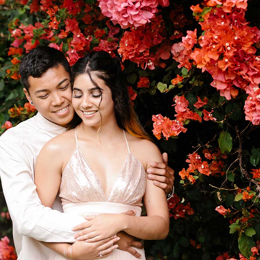 image of couple next to Bougainvillea