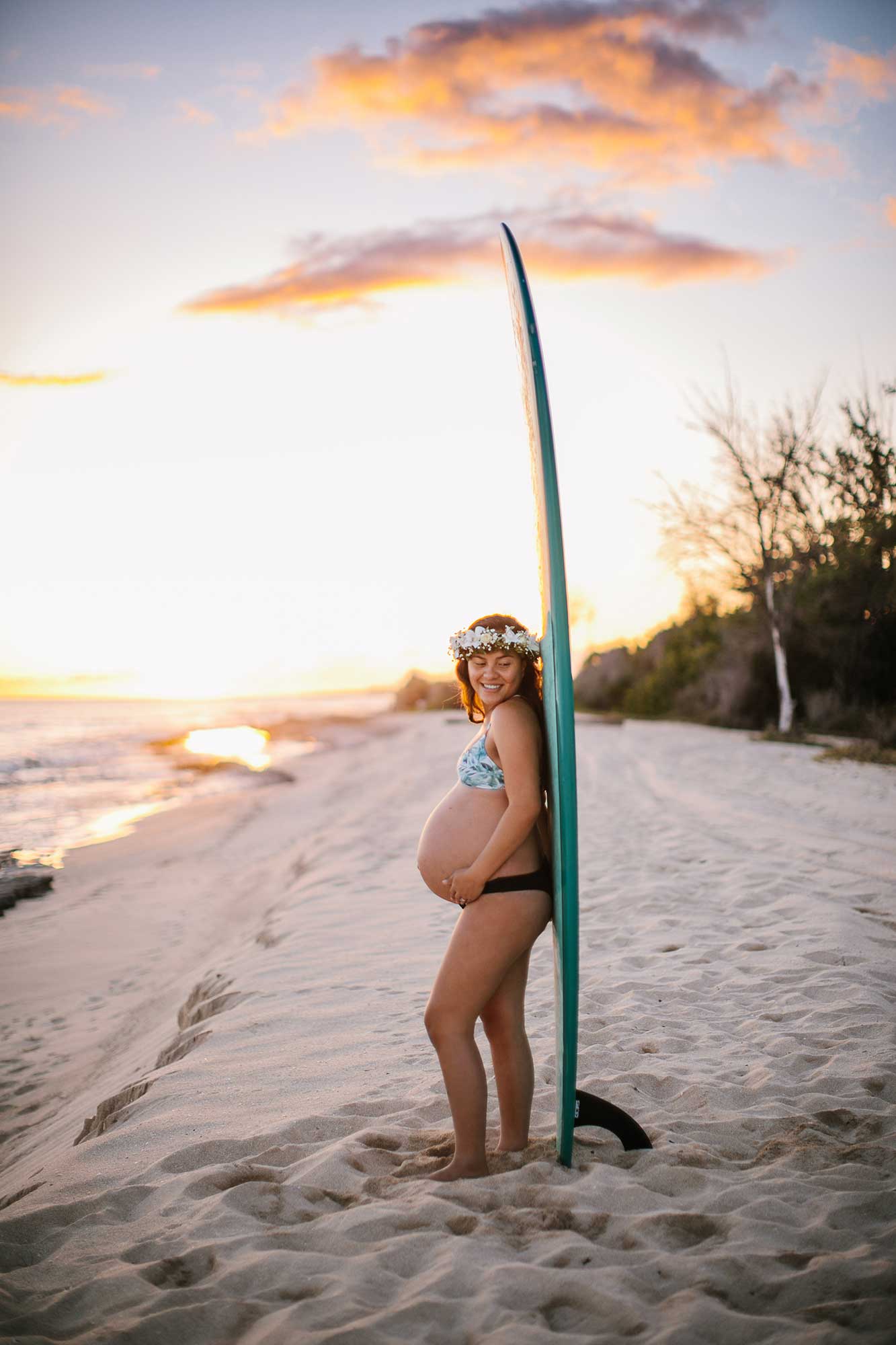 image of pregnant girl standing next to a longboard