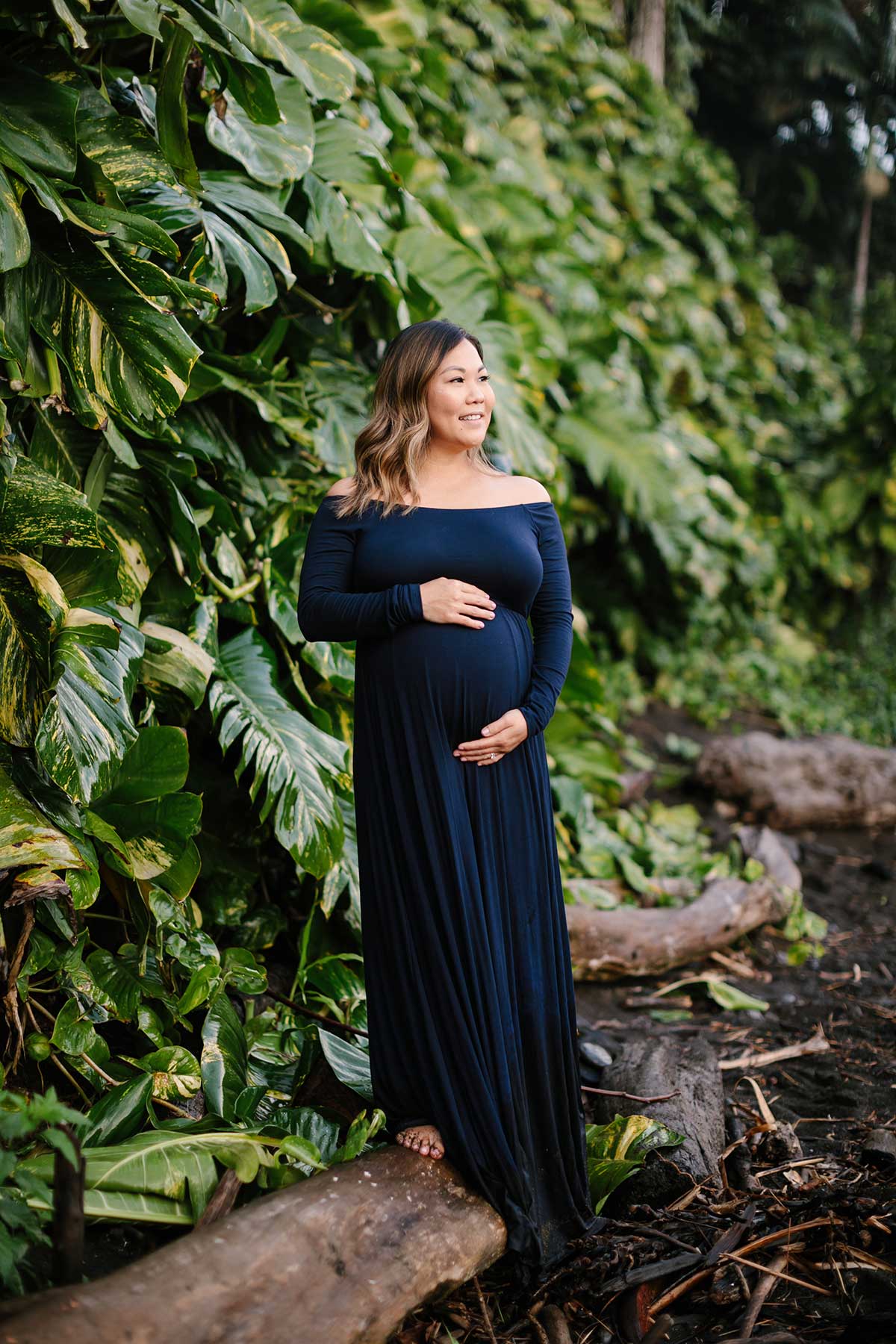 image of pregnant woman standing near the water.
