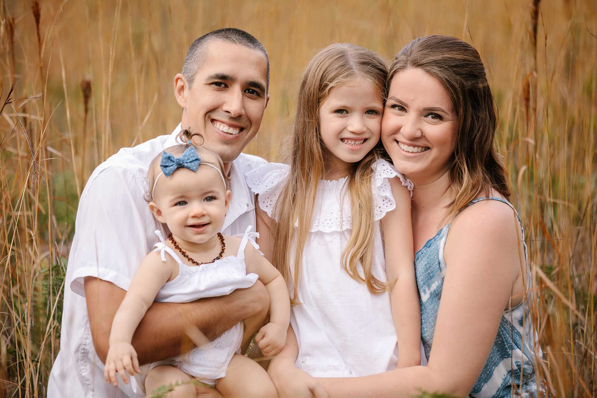 image of couple and their two daughters
