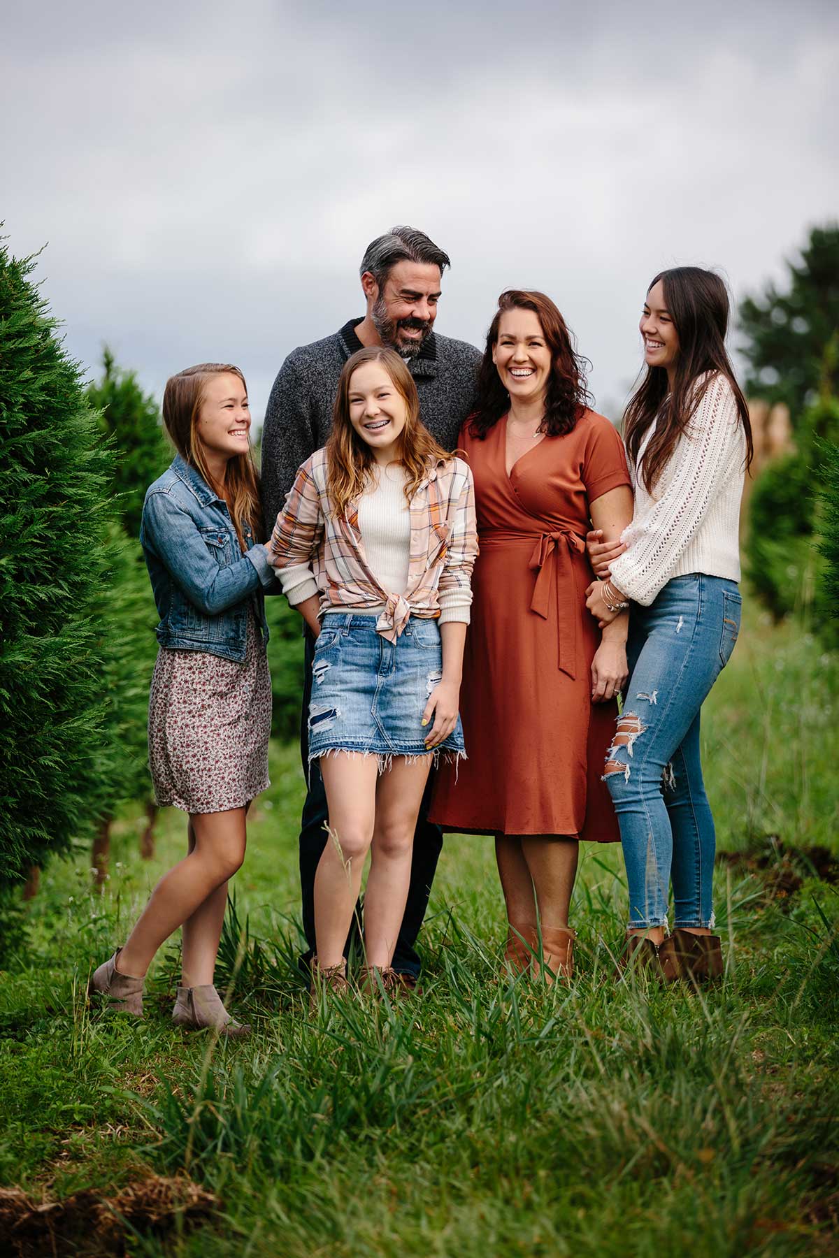 image of couple with their 3 daughters near the forest