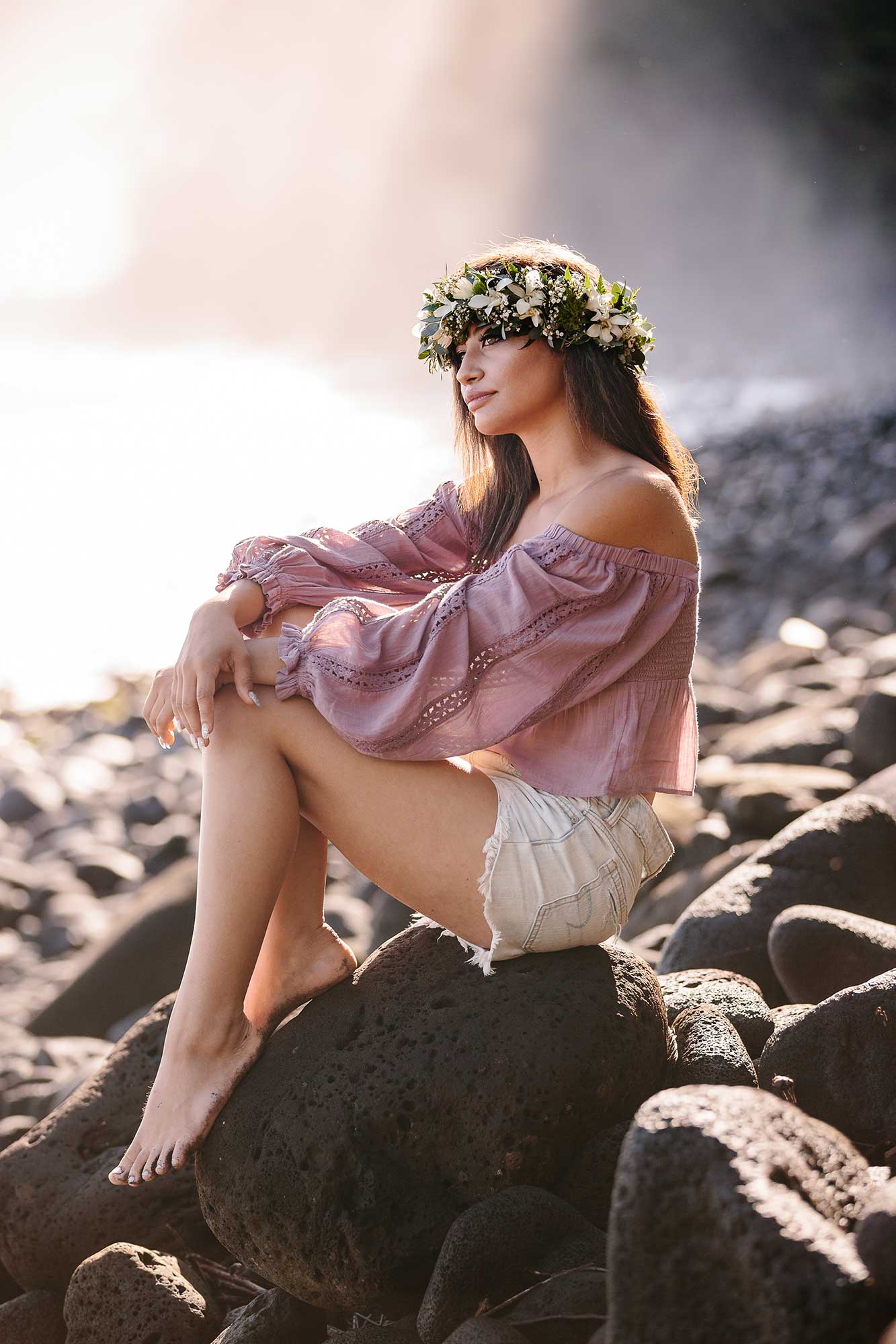 image of a senior portrait of a girl on the rocks near the beach