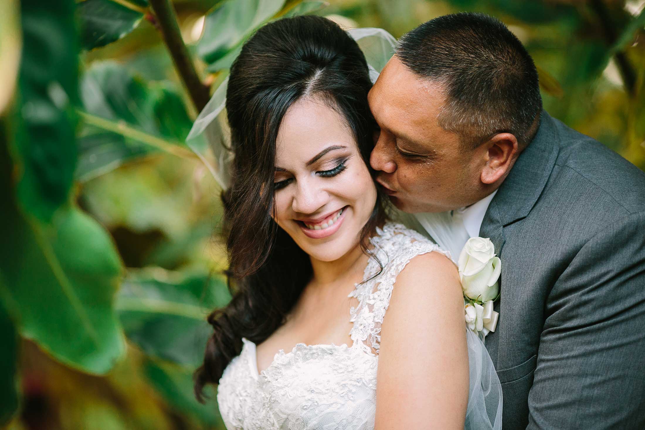 image of groom kissing bride's cheek