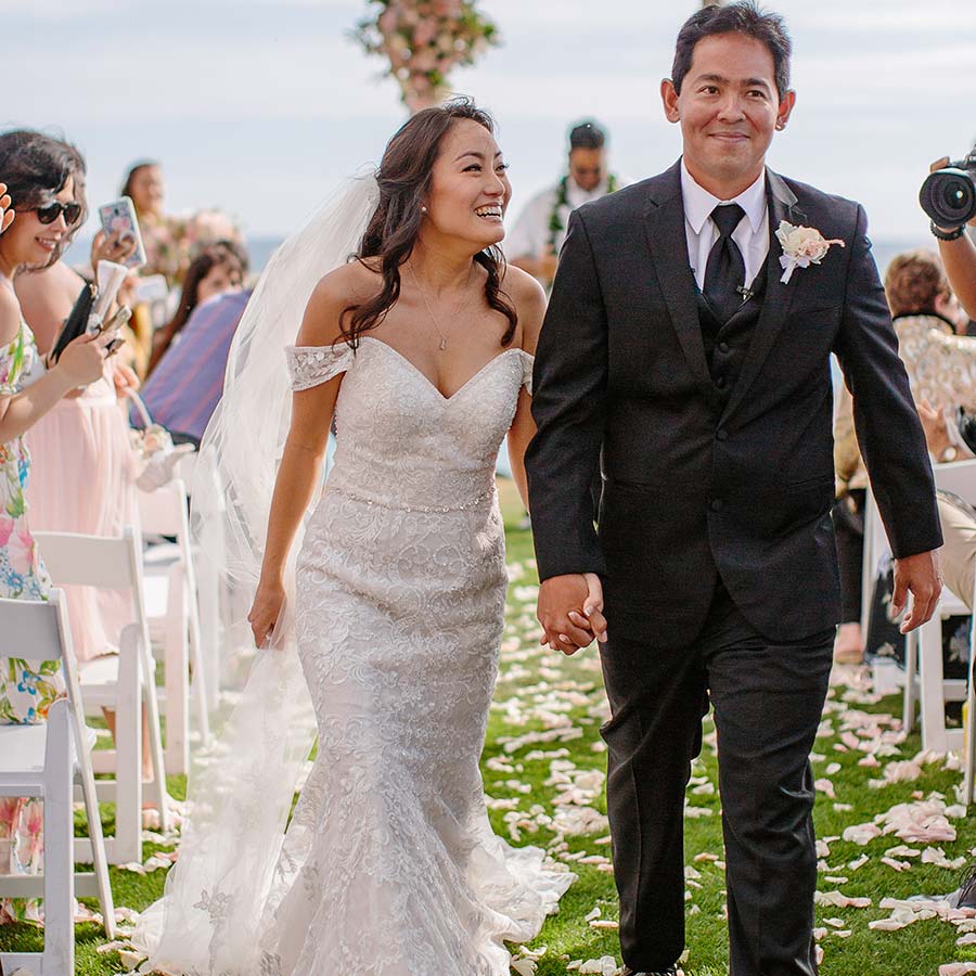 image of married couple walking away from altar